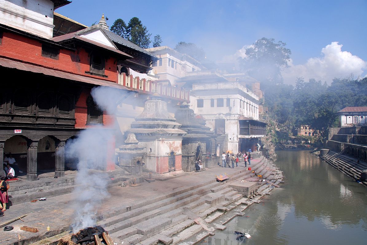 Kathmandu Pashupatinath 09 Burning Ghats Next To Pashupatinath Temple Burning ghats used for cremating the dead jut out on the Bagmati river bank at Pashupatinath in Kathmandu. Male members of the family lay the deceased relative on the wood and straw funeral pyre, and ghee (clarified butter) is laid on the logs to help them burn. Please show discretion for these intensely personal religious affairs.